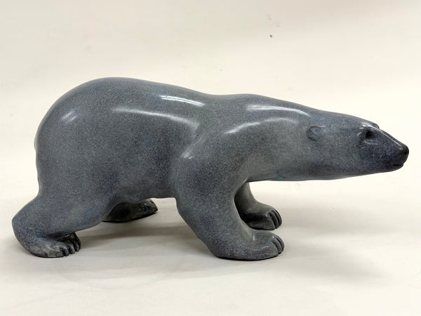 Bronze polar bear sculpture by Cathryn Jenkins, shown in a strong grounded stance with detailed surface texture capturing the animals quiet power and presence